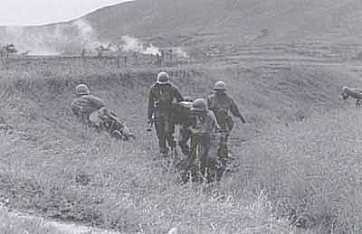 Infantrymen helping a wounded comrade